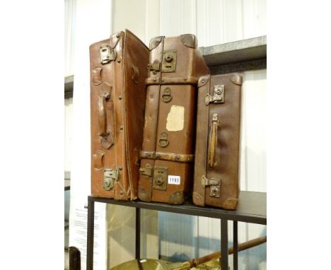 LEATHER SUITCASES. Collection of three vintage leather suitcases