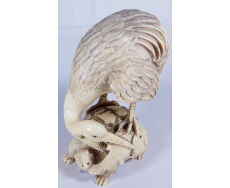 ANTIQUE NETSUKE. Antique hand carved ivory netsuke of heron and turtle eating a carp, signed to base, H - 10cm