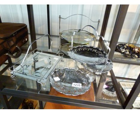 CUTLERY AND DISPLAY STANDS. Shelf of boxed cutlery and three silver plated and glass cake display stands