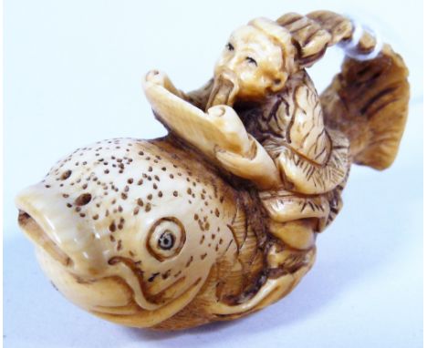 IVORY IMMORTAL NETSUKE. Ivory immortal on fish netsuke, H: 3 cm