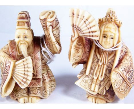 IVORY MAN & WOMAN NETSUKE. Ivory man and woman with fan netsuke, H: 6 cm