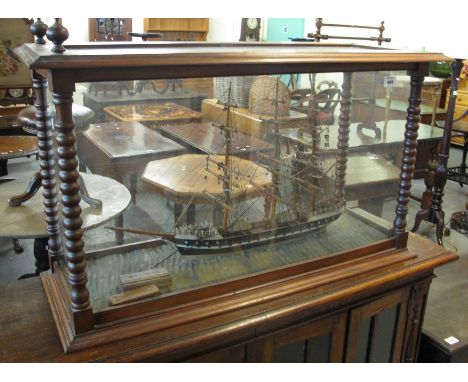 Painted and wood model of the Cutty Sark in glazed mahogany case with bobbin turned supports. (B.P. 24% incl. VAT)