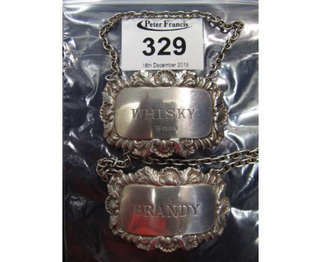 Pair of silver decanter labels, 'Brandy' and 'Whisky' with foliate repousse borders on chains. London hallmarks. (2)(B.P. 24%