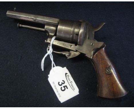 Late 19th Century pin fire revolver having wooden grips and integral ramrod. Antique firearm, no permit required. (B.P. 24% i