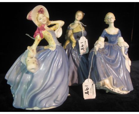 Three Royal Doulton bone china figurines to include; 'Autumn Breezes' HN3736, 'Adrienne' HN2304 and 'Hilary' HN2335. (3)(B.P.
