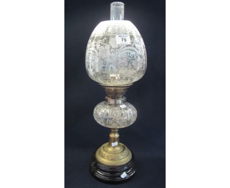 Early 20th Century double burner oil lamp with cut glass reservoir on yellow metal pedestal base with ceramic platform, etche