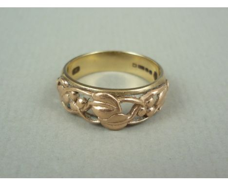 An Art Nouveau style 9ct gold ring, the open face surmounted by trailing foliage, 4.5g