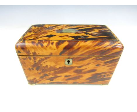 A tortoiseshell tea caddy, of rounded rectangular form raised over ivory bun feet, string inlaid with nickel cartouche and ke