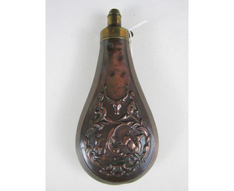 A 19th Century copper powder flask, the body embossed in a design incorporating a stag hunting vignette, 18.5 cm