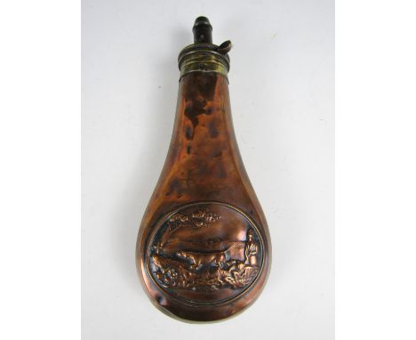 A 19th Century copper powder flask, the body embossed in a design incorporating a hunting vignette, the patent nozzle having 