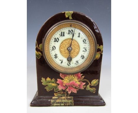 A late 19th Century Aesthetic Movement ceramic mantle clock, decorated with tumbling pink poppies, having a white enamelled f