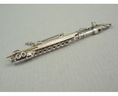 A vintage novelty white-metal bar brooch modelled in the form of a flute, tests as silver, 5.5 cm, 3.8g
