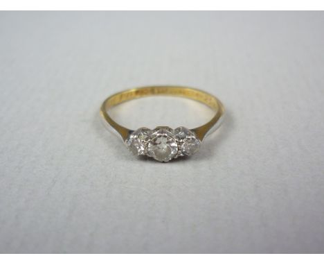 A 1930s three stone diamond engagement ring, the central brilliant-cut diamond of approximately .16ct flanked by two further 