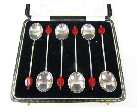 A cased set of six George V silver coffee spoons, each having a red celluloid coffee bean finial, Arthur Price, Birmingham, 1