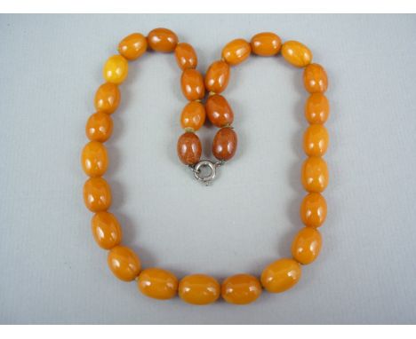 A vintage single strand necklace of uniform butterscotch amber beads, each bead approximately 1.4 x 1 cm, 25.6g