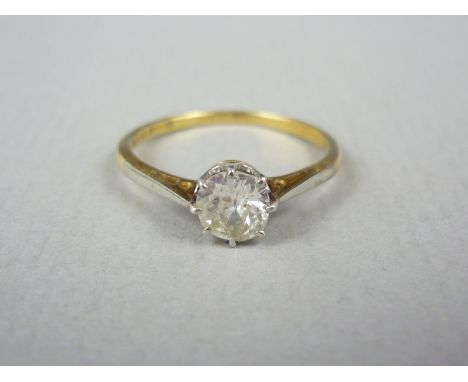 An early 20th Century diamond solitaire ring, the brilliant cut diamond of approximately .50ct, crown set in platinum within 