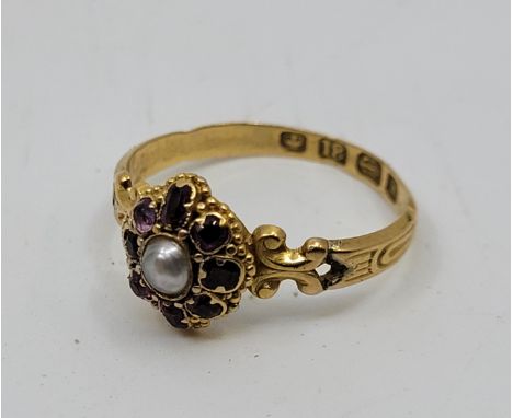 A Victorian 18ct. gold pearl and garnet ring, Birmingham 1861, the octofoil mount with cultured pearl in rub over setting to 