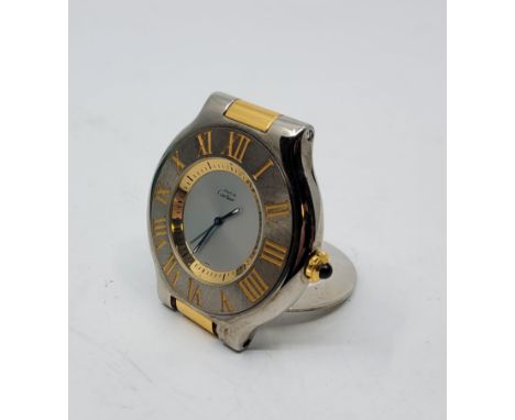 A Must de Cartier bi-colour quartz alarm table clock, having signed circular dial with luminous tipped blued hands, bezel wit