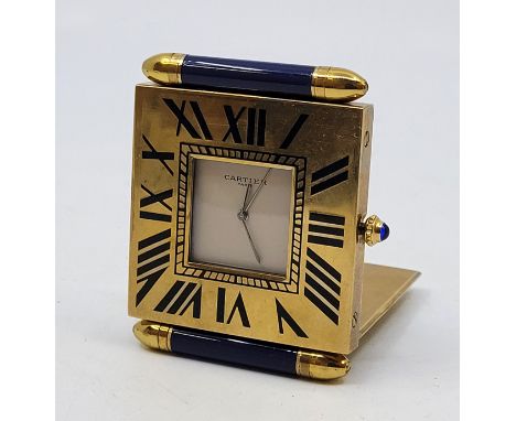 A Cartier gilt brass travelling alarm table clock, quartz movement, having signed square dial and Roman numeral chapter with 