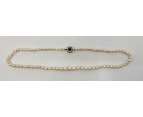 A cutured pearl necklace, with 9ct. gold clasp set green turquoise cabochon to centre bordered by ring of cultured pearls, le