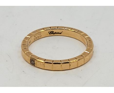 A Chopard 18ct. yellow gold and diamond set single row "Ice cube" band ring,&nbsp;flush set single round brilliant cut diamon