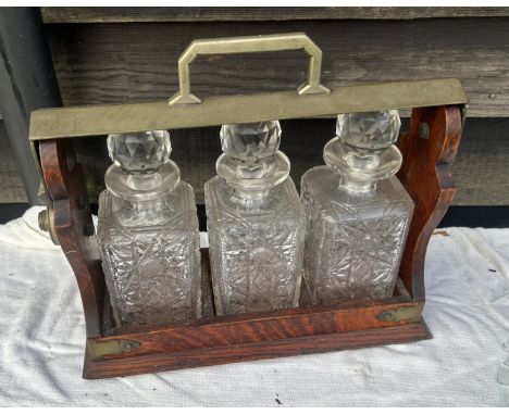 A 19th cent oak cased tantalus and a silver plated decanter set&nbsp;