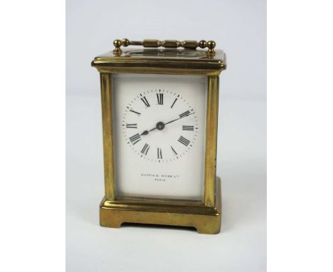 A small brass cased carriage clock, signed Mappin &amp; Webb Ltd, Paris, in a standard plain four glass case, enamel dial, wi