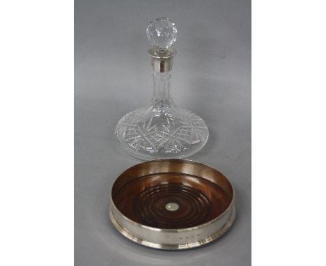 A MODERN SILVER DECANTER COASTER, plain exterior, mahogany inset base, maker J.A. Campell, London 1991, diameter approximatel