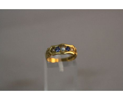 A LATE VICTORIAN SAPPHIRE AND SPLIT PEARL HALF HOOP RING, fancy scroll detail to the shoulders, ring size N, hallmarked 18ct 