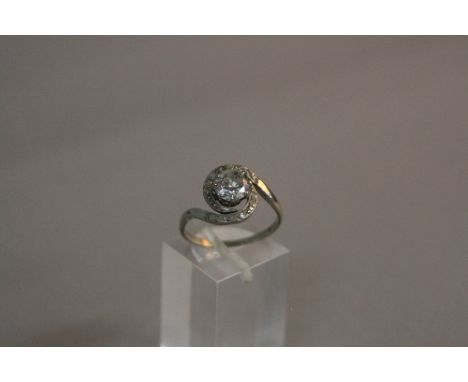AN EARLY - MID 20TH CENTURY DIAMOND RING, circa 1940, centring on a principle brilliant cut diamond enclosed within an old mi