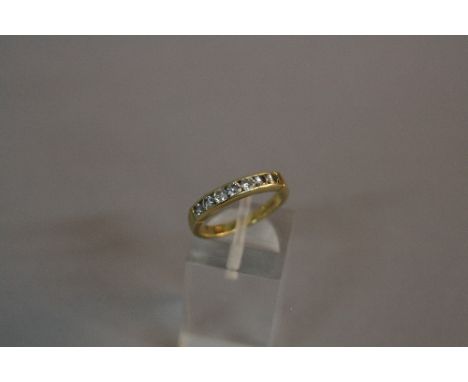 A LATE 20TH CENTURY 18CT GOLD SEVEN STONE DIAMOND HALF ETERNITY RING, diamonds channel set, total modern round brilliant weig