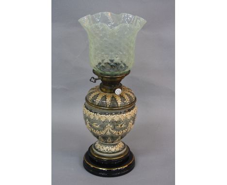 A LATE VICTORIAN OIL LAMP, trellis pattern vaseline glass shade with wavy rim, the ovoid grey/blue ceramic base decorated in 