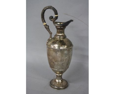 A VICTORIAN SILVER HOT WATER JUG, of ewer form, beaded rim, fluted neck, scrolled cast handle with bone insulators and termin
