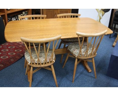 AN ERCOL BLONDE ELM RECTANGULAR DINING TABLE, approximate length 153cm x width 84cm x height 74cm and four chairs with crosse