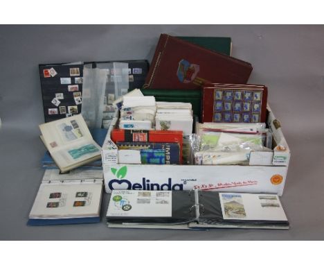 AN ACCUMULATION OF STAMPS AND COVERS, in albums and loose, contained in two boxes with Great British First Day covers