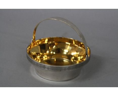A MODERN RUSSIAN SILVER CIRCULAR BASKET, swing handle, Greek key border, gilt interior, various marks, including hammer and s