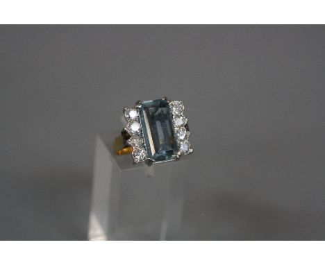 A LATE 20TH CENTURY AQUAMARINE AND DIAMOND RECTANGULAR SHAPE DRESS RING, emerald cut aquamarine measuring 14.6 x 7.6 x 3.7, c