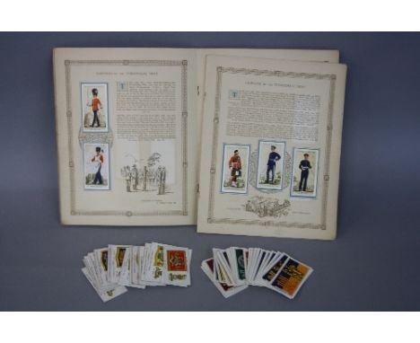 AN ALBUM CONTAINING A FULL SET OF UNIFORMS OF THE TERRITORIAL ARMY,  by John Players & Sons, the full set of coloured cards a