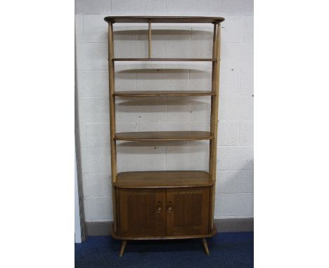 AN ERCOL BLONDE ELM ROOM DIVIDER/SHELVES, the two central shelves being adjustable above a cupboard base, approximate width 9