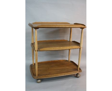 AN ERCOL BLONDE ELM THREE TIER SERVING TROLLEY, approximate width 72cm x depth 46cm x height 75cm