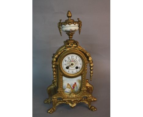 A MID 19TH CENTURY STYLE GILT METAL MANTEL CLOCK, pineapple finial on a porcelain urn (s.d.), on an arched top with ribbon an