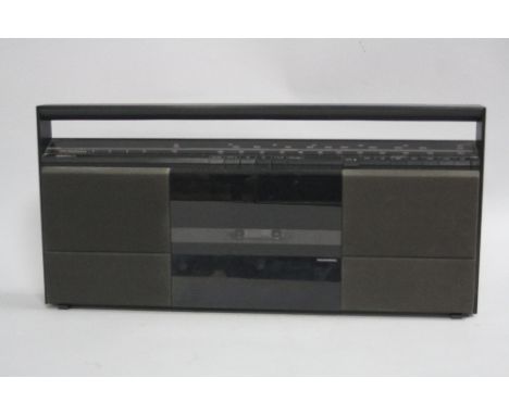 A BANG & OLUFSEN BEOSYSTEM 10 RADIO CASSETTE PLAYER, constructed of matt black aluminium with fabric speaker grilles