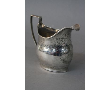 A GEORGE III SILVER HELMET SHAPED CREAM JUG, strap work handle (solder to join with jug), bright cut decoration, laurel leaf 