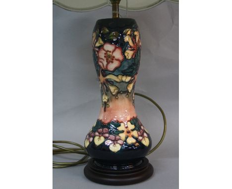 A MOORCROFT POTTERY OBERON PATTERN TABLE LAMP, mounted on a wooden plinth base, together with a pale green light shade, heigh