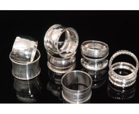 A small parcel lot of nine hallmarked silver napkin rings, various designs to include plain, engine turned, foliate engraved 
