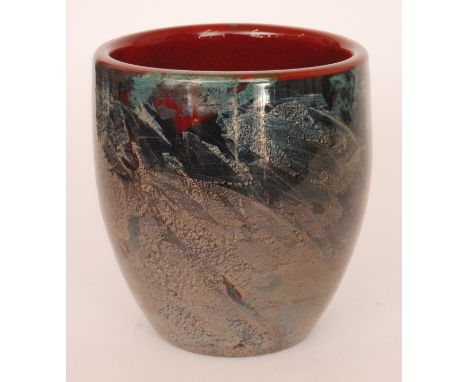 A 20th Century studio glass vase of barrel form decorated with foil aventurine panels over a ruby ground, engraved Manna to t