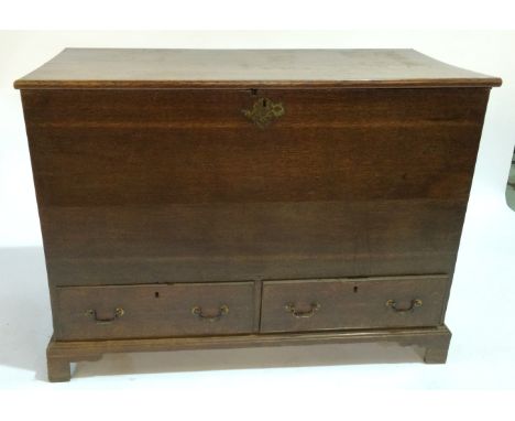 A George III oak mule chest, fitted with two drawers over bracket feet, width 124cm.