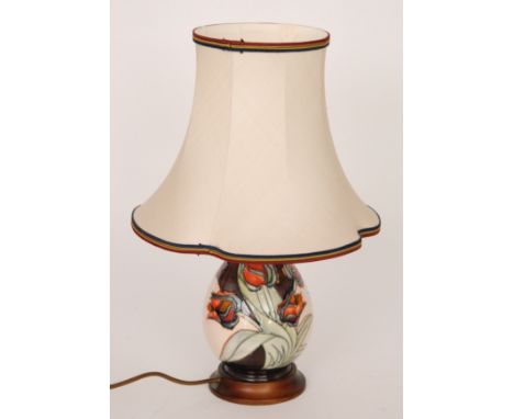 A Moorcroft Pottery table lamp decorated in the Red Tulip pattern designed by Sally Tuffin, affixed to a wooden plinth, compl