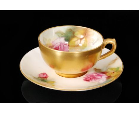 A Royal Worcester cabinet cup and saucer decorated by Pilsbury with pink roses and foliage, signed, puce mark with date code 