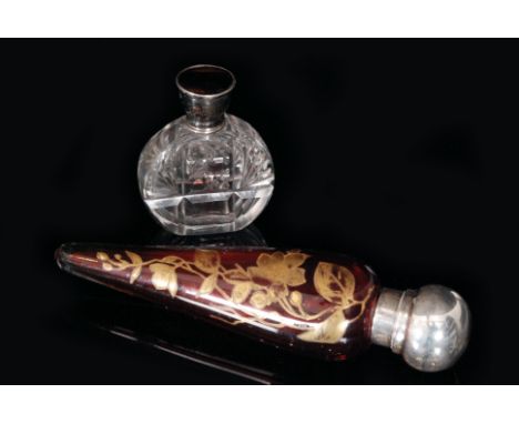A Victorian hallmarked silver and ruby glass torpedo scent bottle the glass body with gilt ivy leaf decoration below silver c